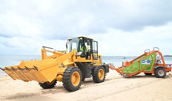 Debris collection device (right) with tractor